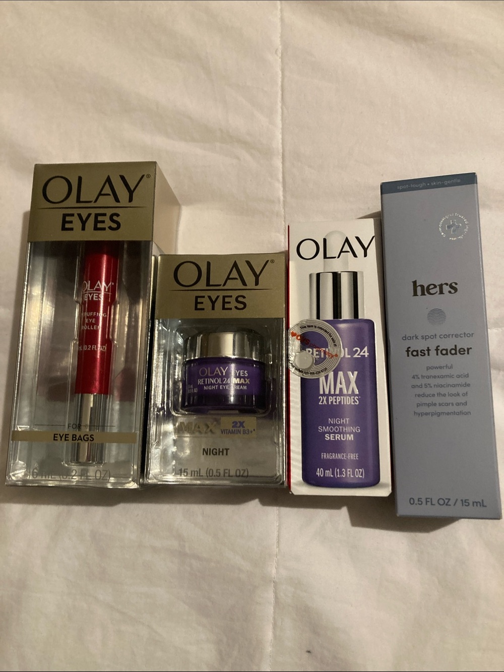 OLAY Eyes and Skincare Set in Red, Purple, White, and hers dark spot corrector